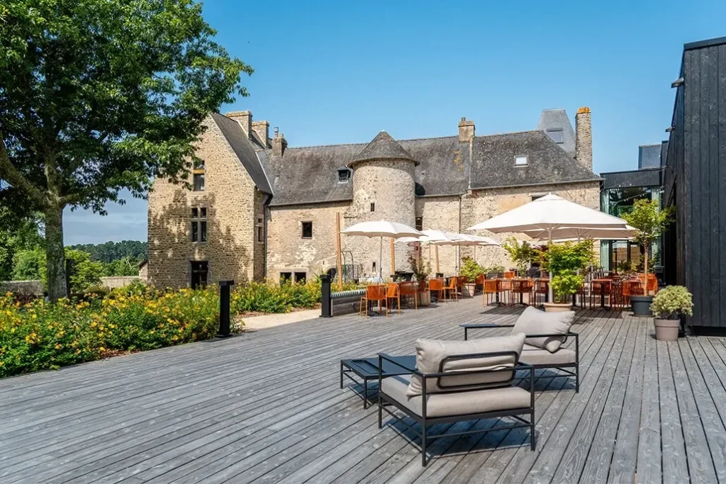 Terrasse en bois avec vue sur le manoir Obono et parasol